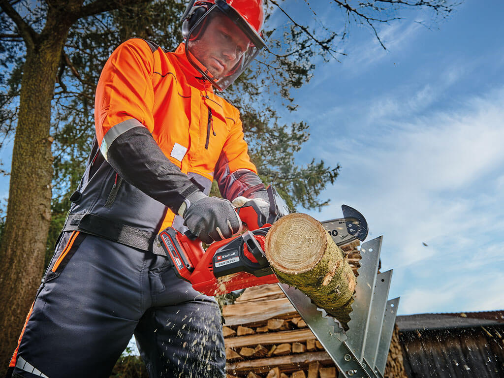 A man using the cordless chainsaw. 