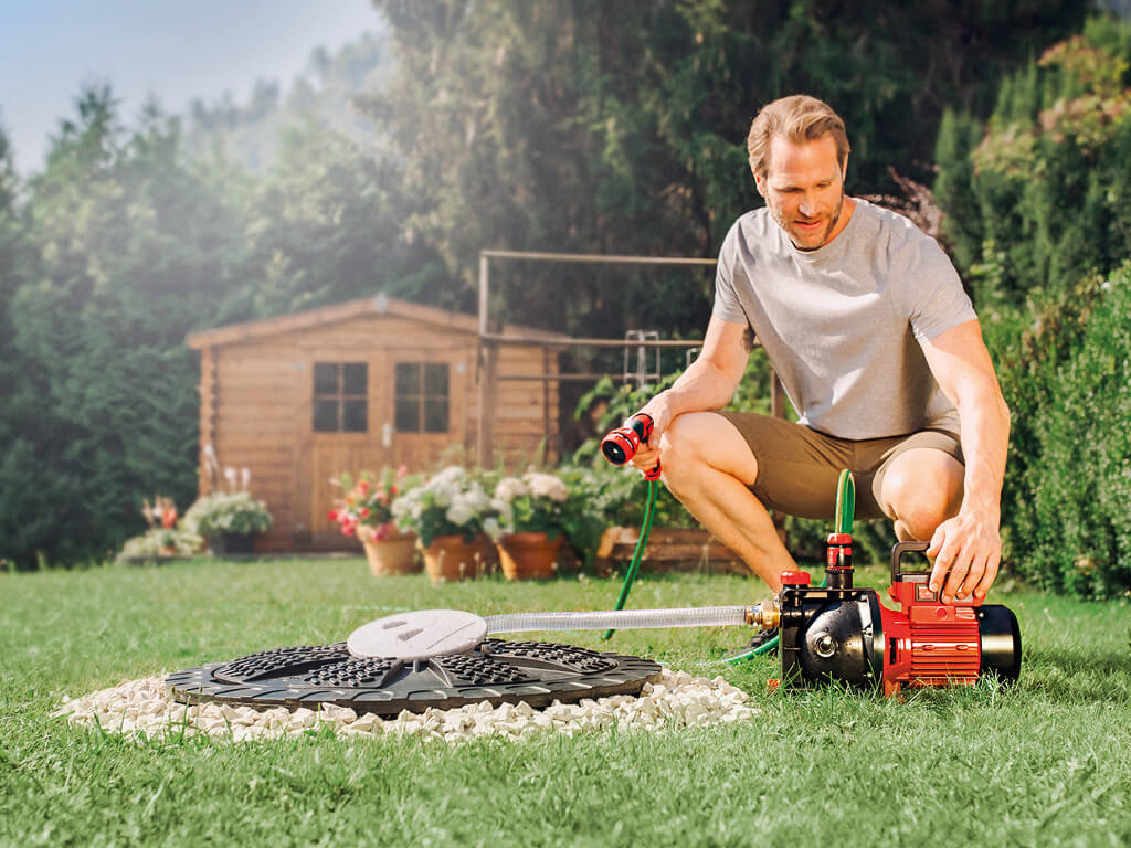 A man is working with his cordless garden pump