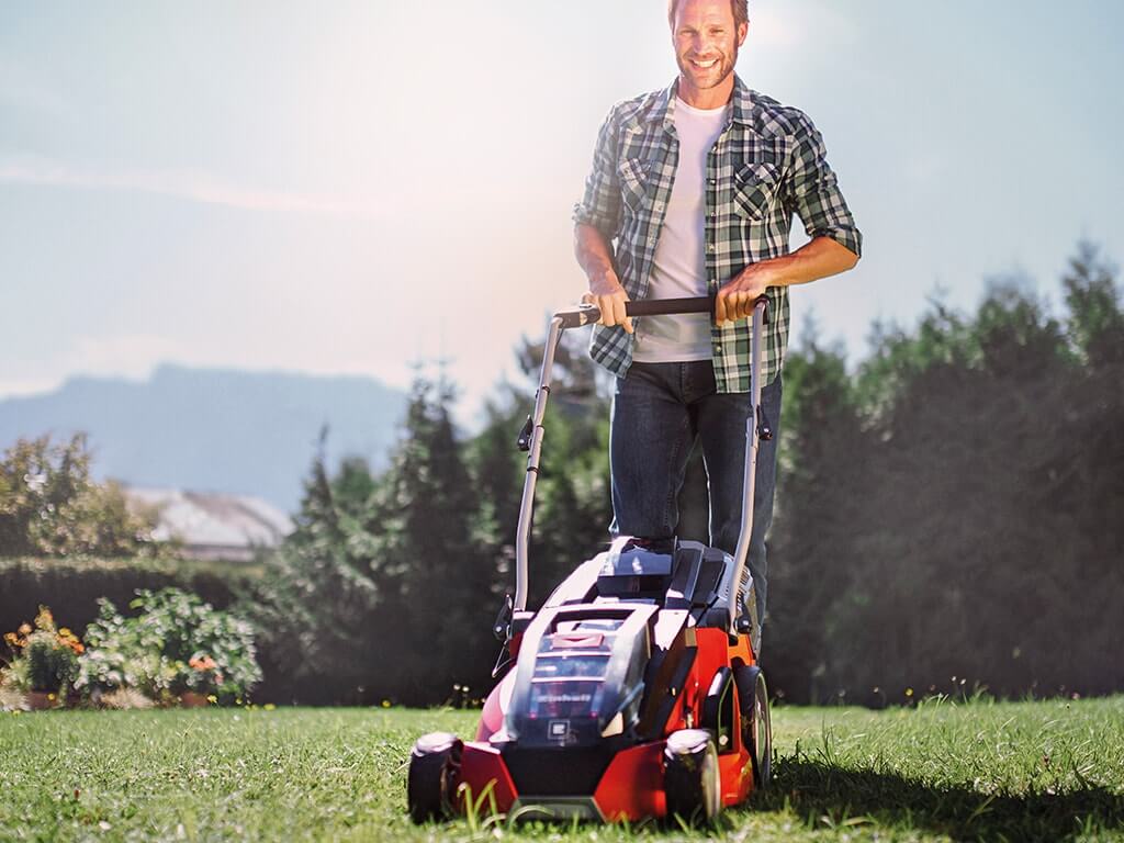 A man mowing the lawn. 