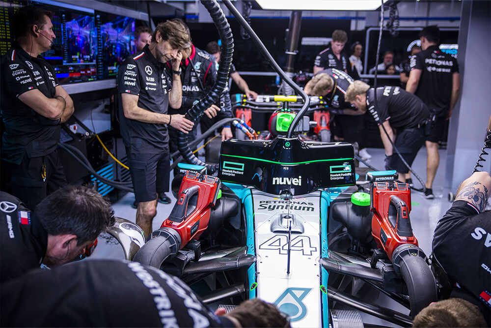 Formula 1 Mercedes race car being surrounded by mechanics and the team.