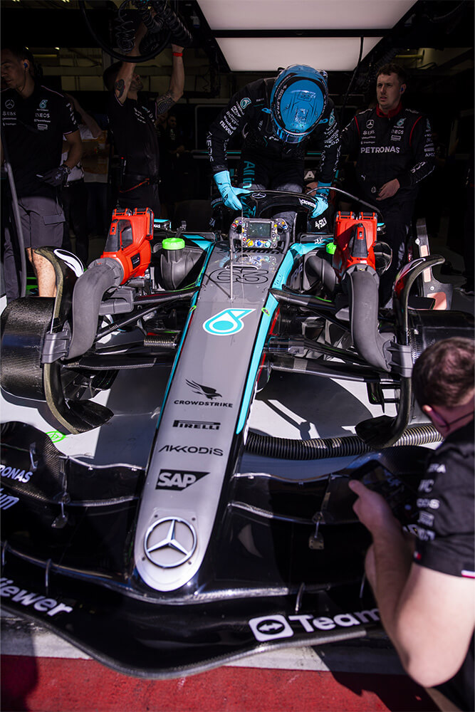 Formula 1 Mercedes race car being surrounded by mechanics and the team.