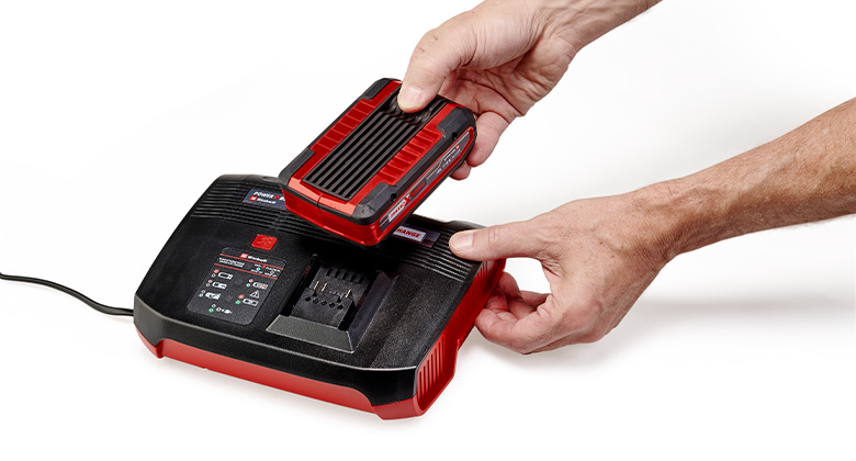 someone puts a Einhell Power X-Change battery in a charger