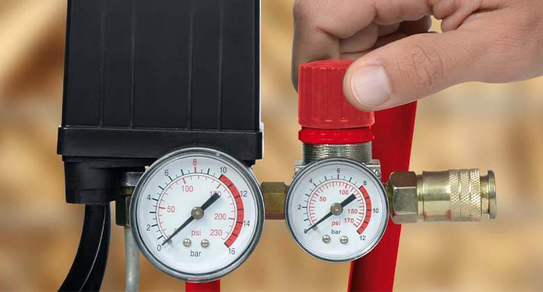 Two pressure gauges measuring and regulating air pressure precisely.