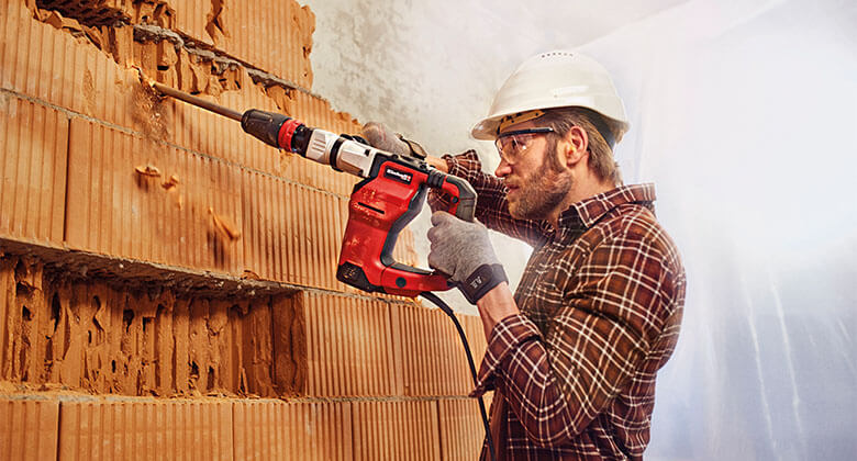 man working with an electric rotary hammer